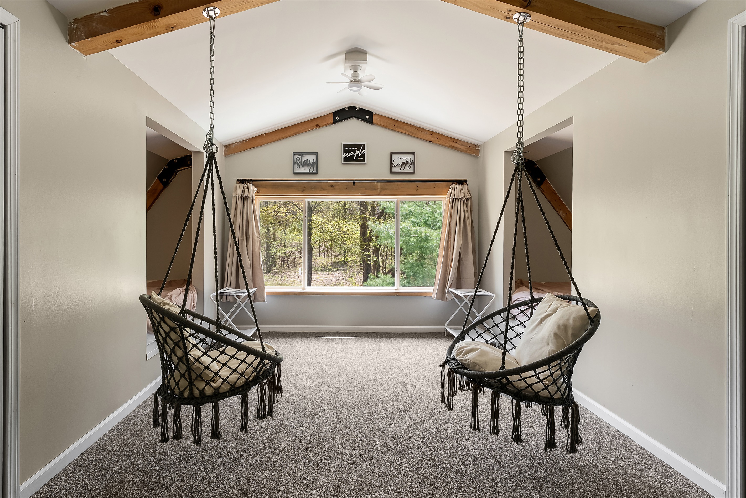Bedroom upstairs with chair swings, 3 full beds and 1 twin bed.