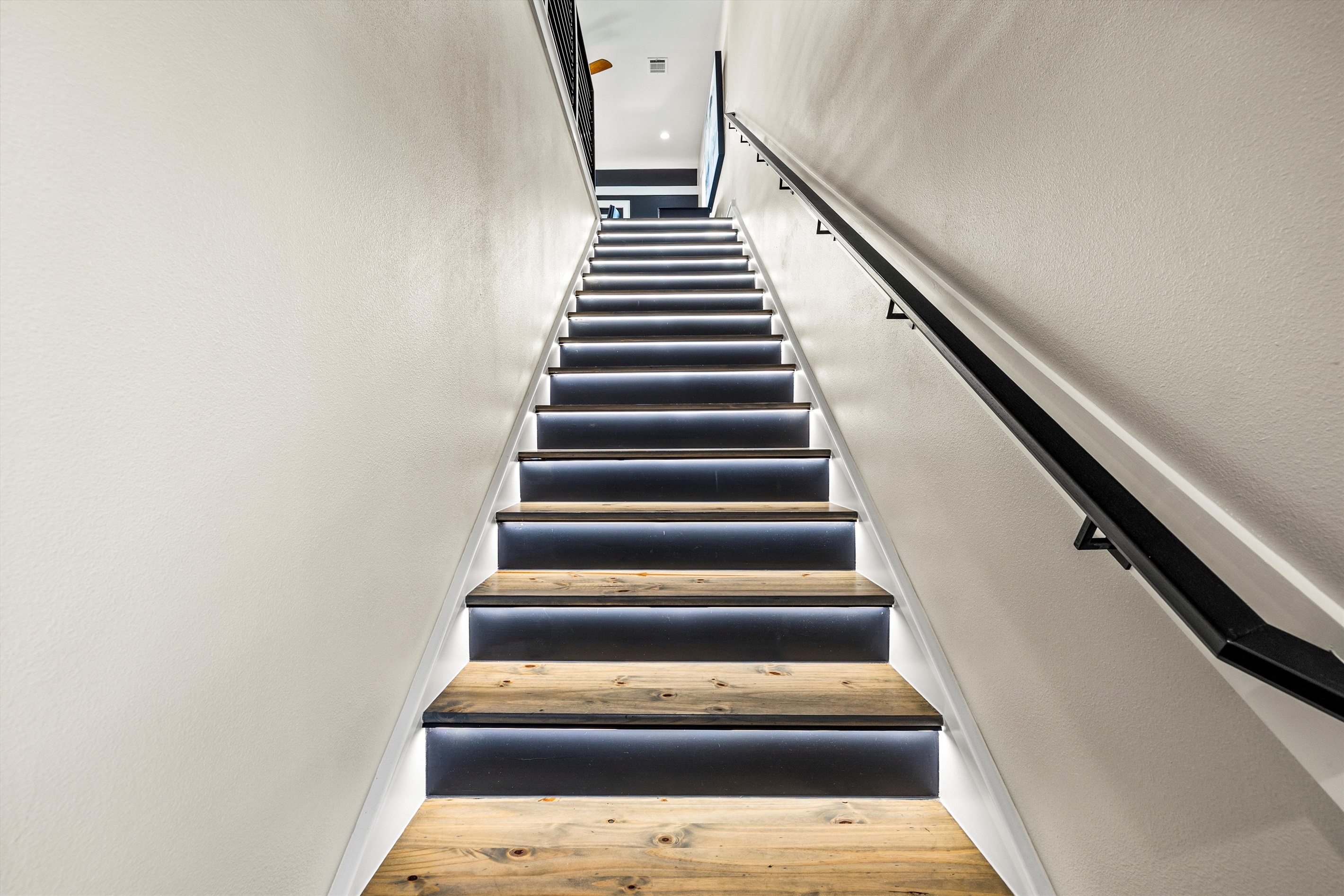 Stairway to Adventure: Illuminate your journey with modern lighting and rustic charm!