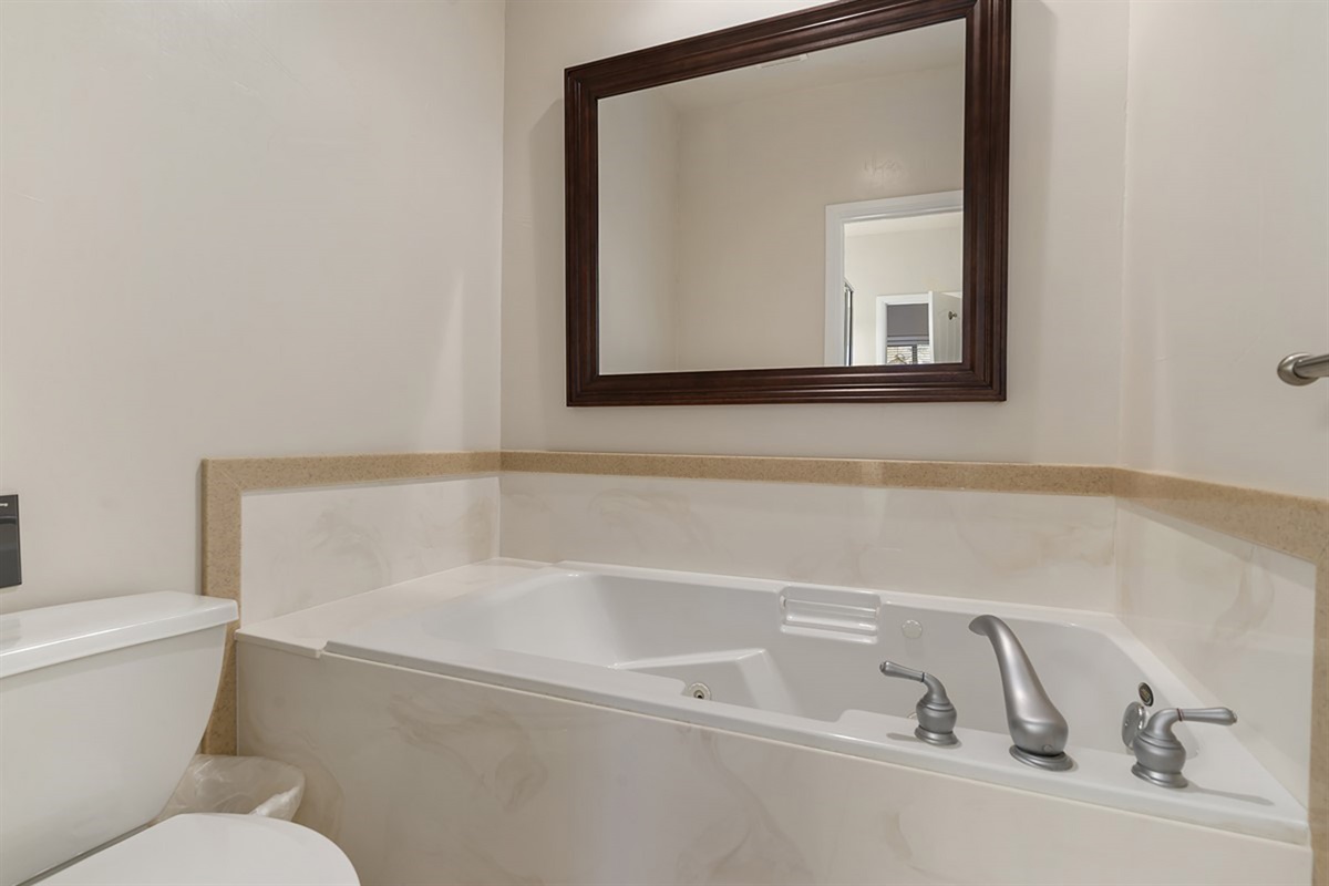 Unwind in a deep jetted soaking tub, offering a tranquil, spa-like retreat after a day of mountain adventures and relaxation.