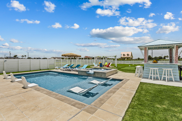 Escape to your own resort-style backyard featuring a sparkling pool, heated spa, and comfortable lounge seating—the perfect place to relax, recharge, and enjoy quality time together.