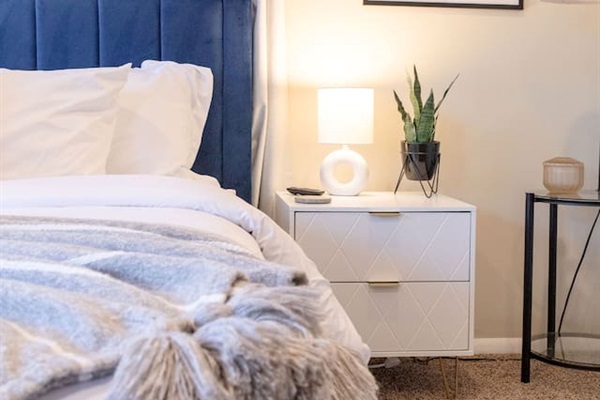 Cozy, spacious room with a queen-sized bed, TV, and a dedicated working space.