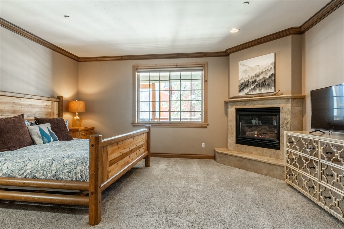 A serene primary suite featuring a king bed, gas fireplace, and generous layout—designed as a true retreat within the Noble Nest.