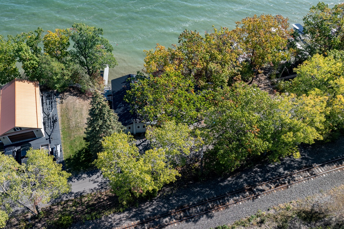 Stunning aerial view showing the private shoreline and cozy lakeside home