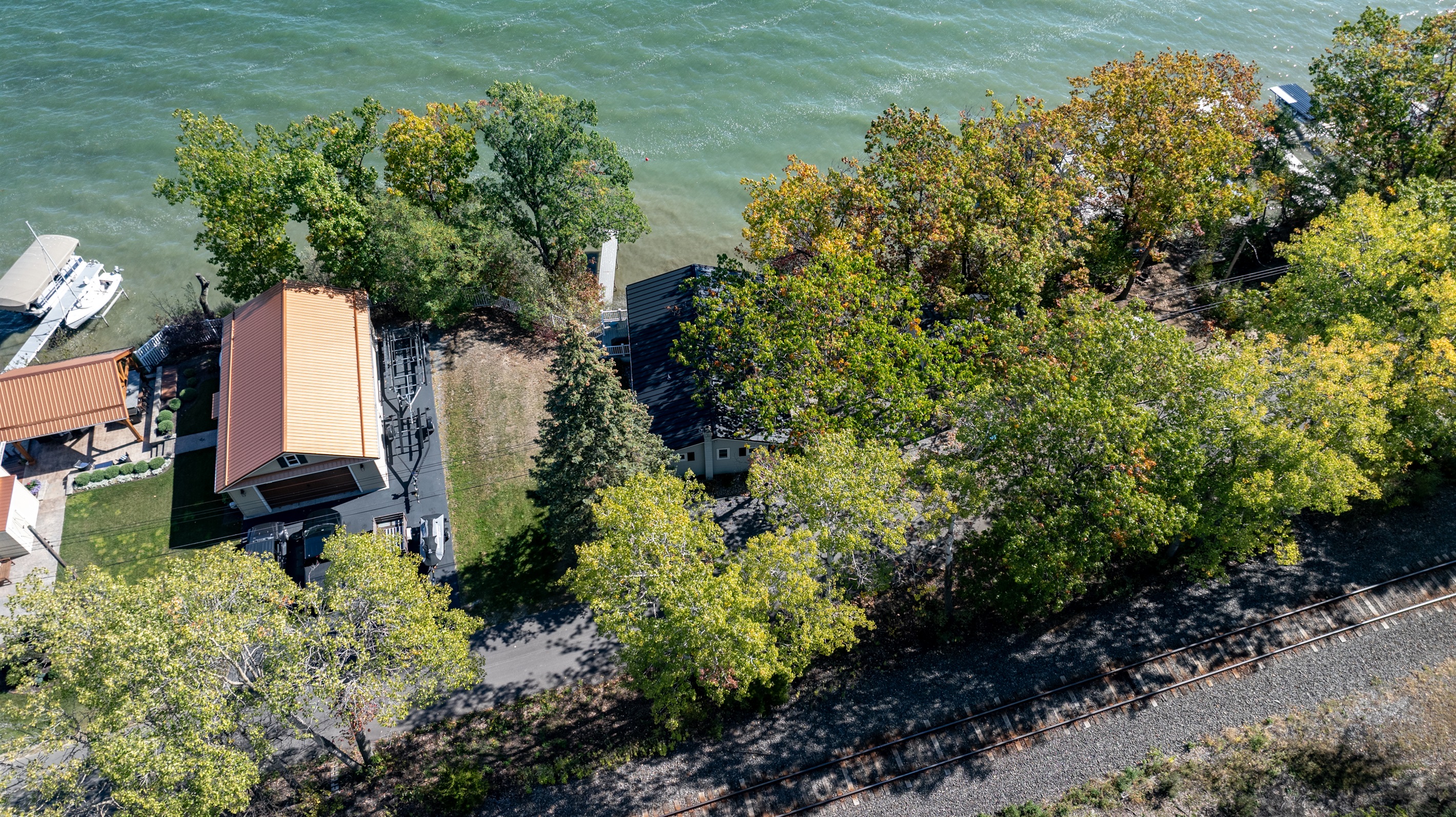 Stunning aerial view showing the private shoreline and cozy lakeside home