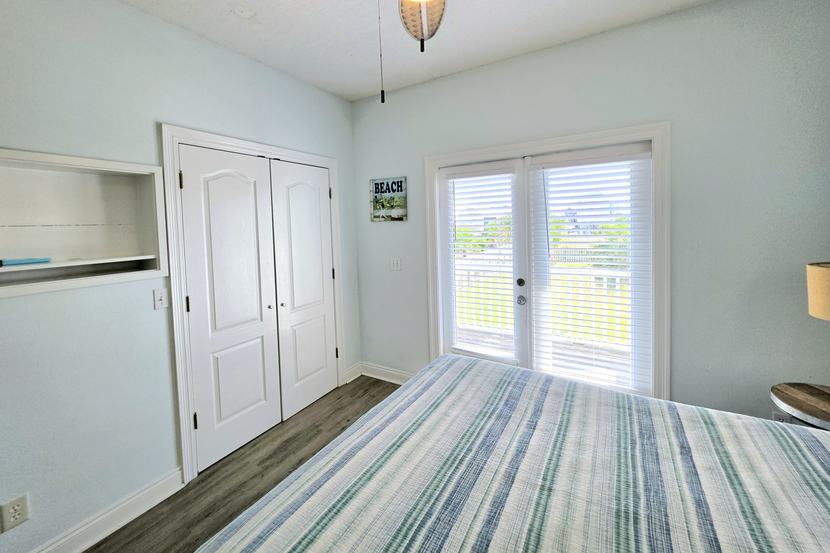 Bedroom with closet and French doors to the balcony