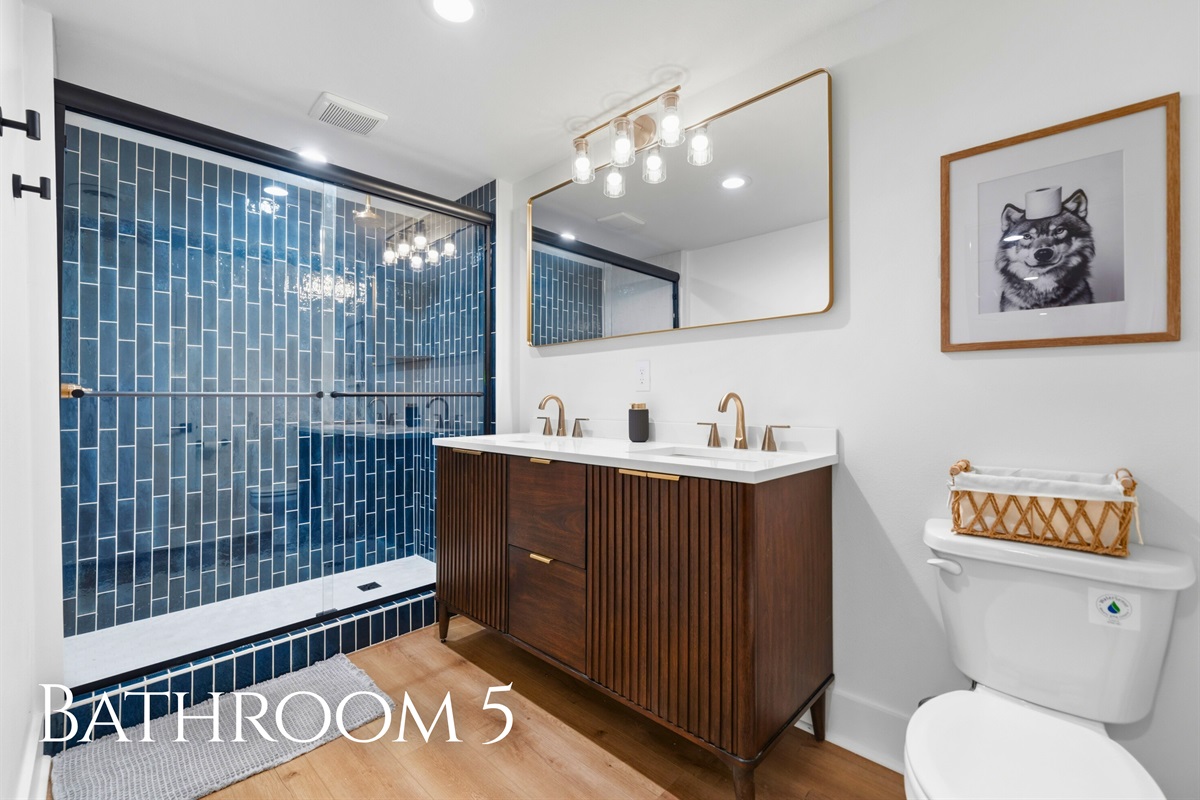 A glass-enclosed shower and updated finishes give this bathroom a clean, modern look.
