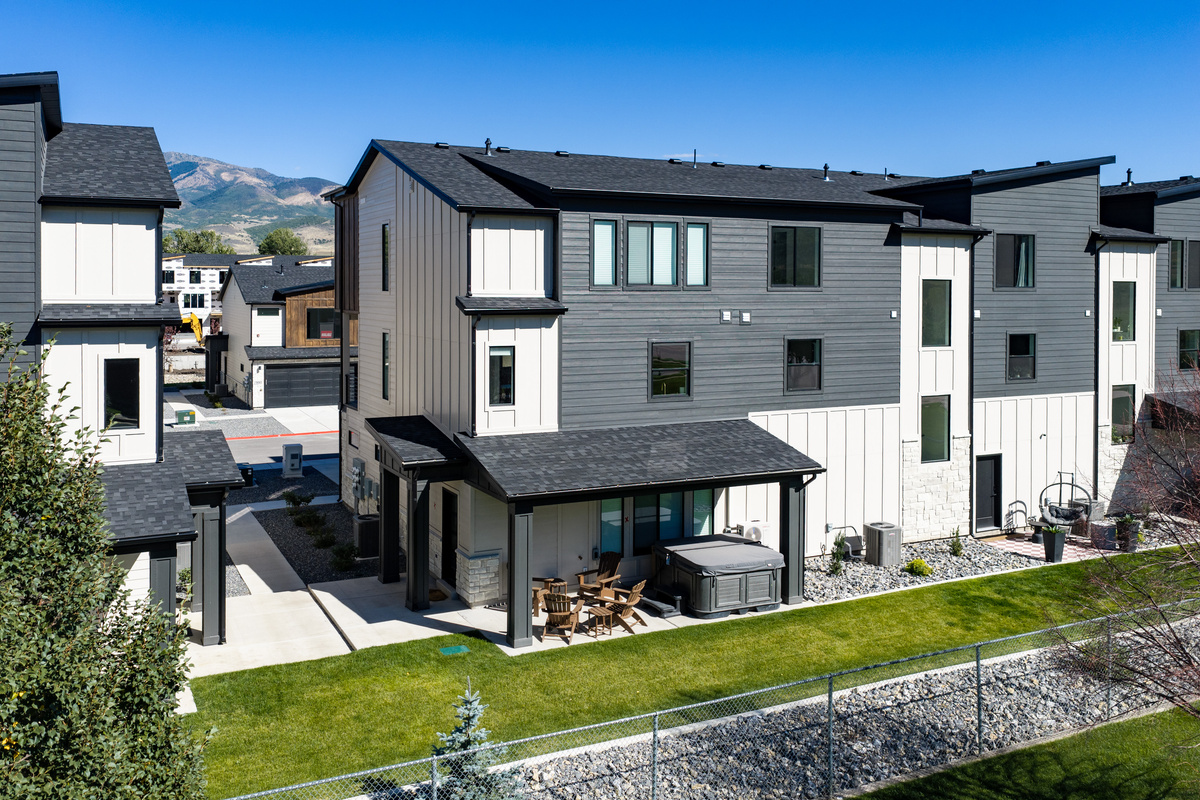 The rear of the home opens to green space and outdoor areas designed for relaxing between adventures.