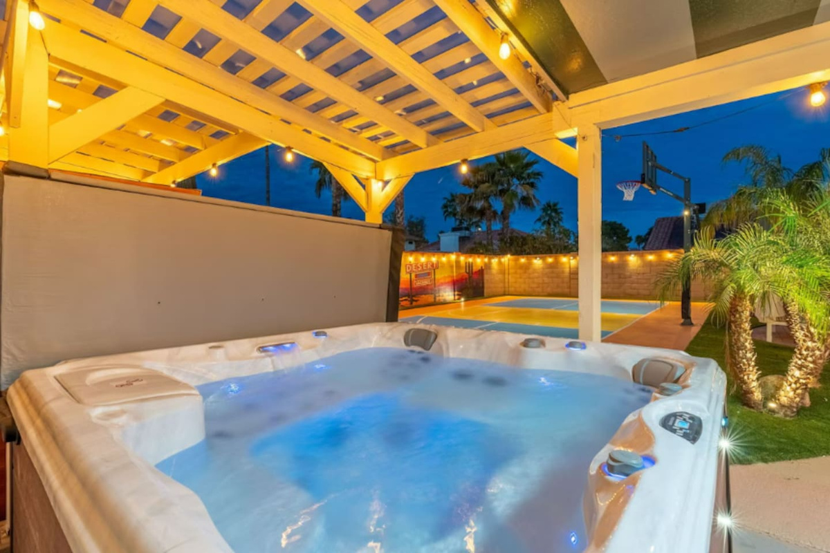 Spa-like hot tub under the stars — your private resort escape with views of the grounds and palm-lined landscape.
