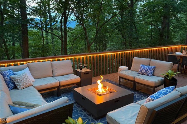 Outdoor lounge area with propane fire table.