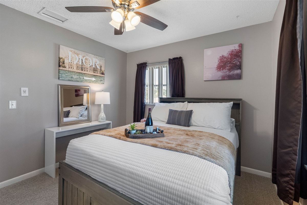 Neutral walls, crisp white bedding, and subtle accents provide timeless style and comfort.
