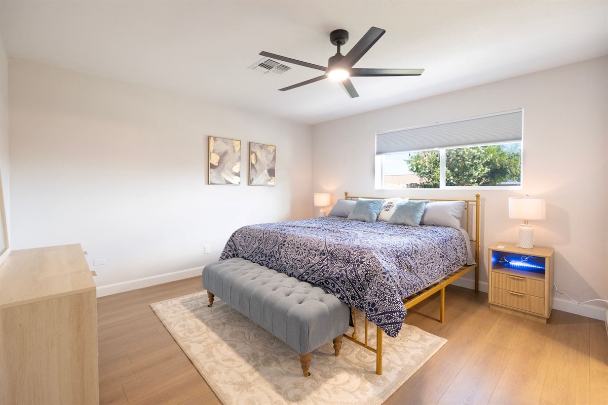 Unwind in comfort—spacious bedroom with plush bedding, soft tones, and a peaceful place to recharge after a day in Scottsdale