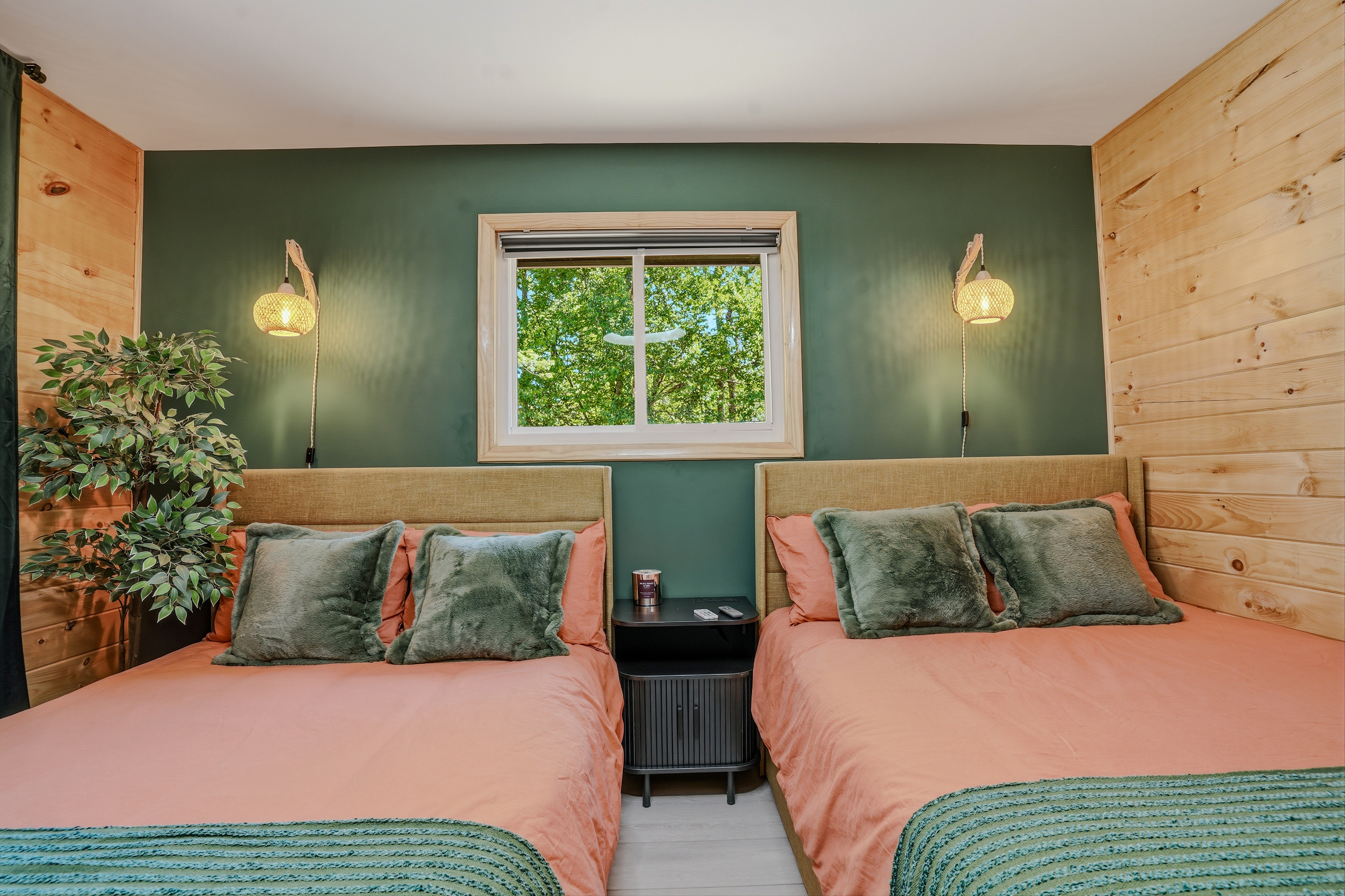 Fifth bedroom alternate angle — warm tones, layered bedding, and natural wood walls