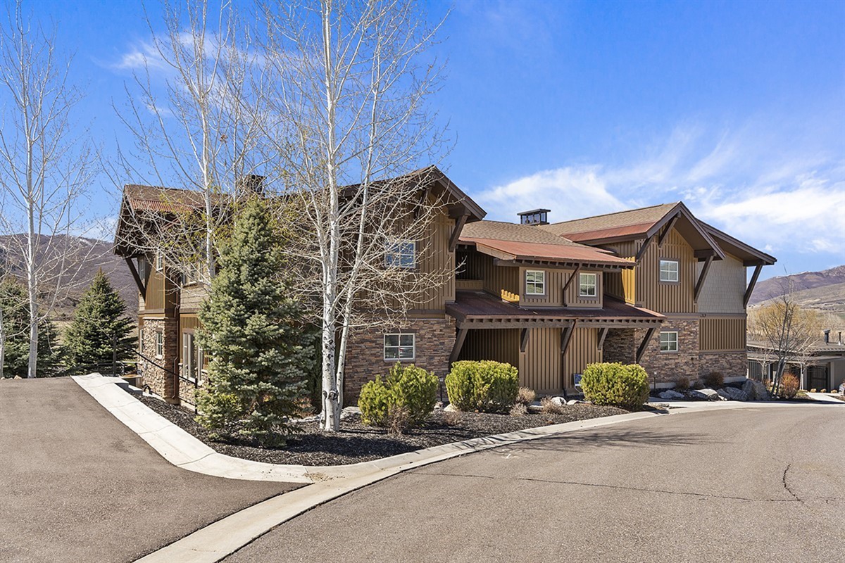A refined exterior, well-maintained neighborhood, where mountain-inspired architecture and natural surroundings create a sense of understated elegance.