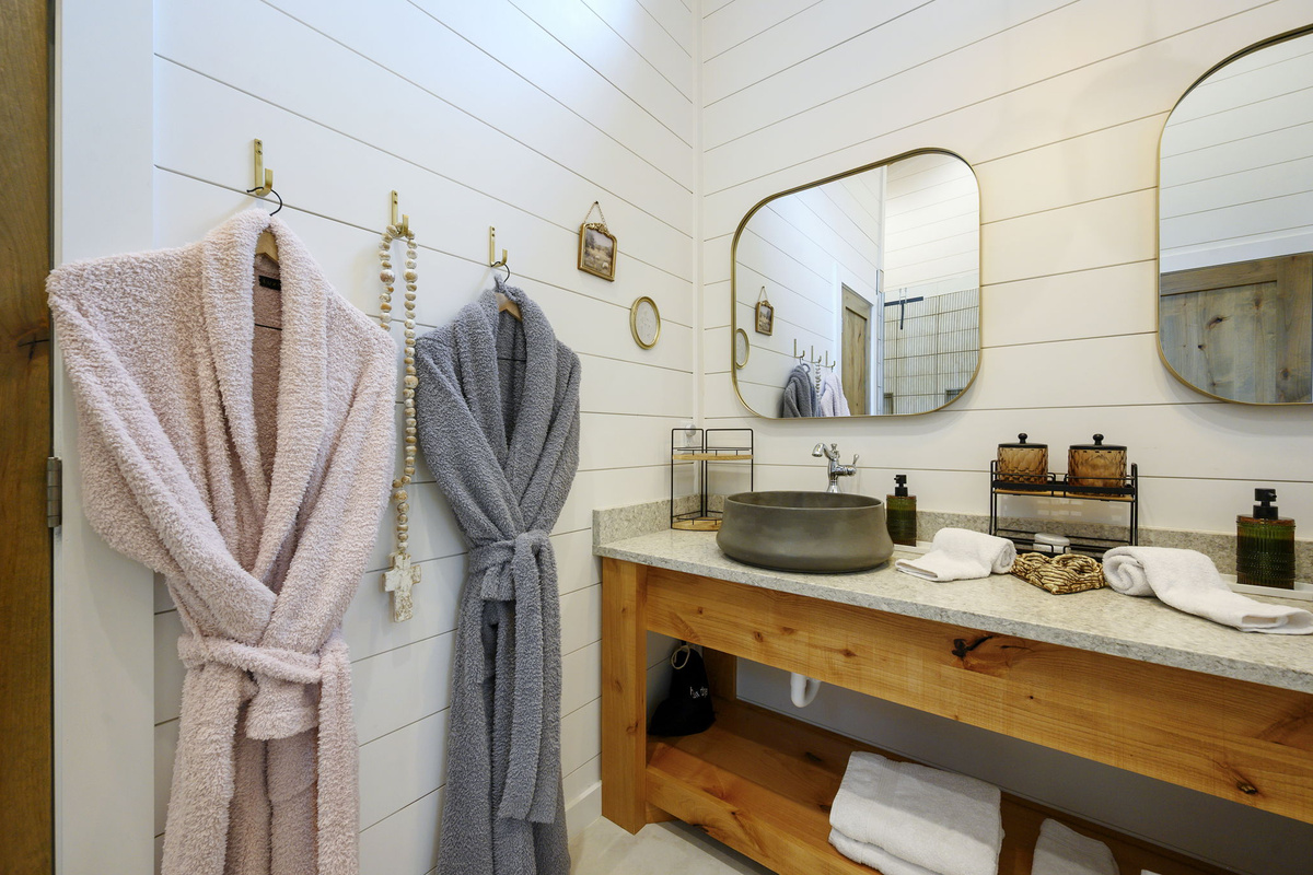 The primary ensuite bathroom offers a warm, spa-like experience with high-end finishes, luxurious touches, and a serene atmosphere designed for comfort and relaxation.