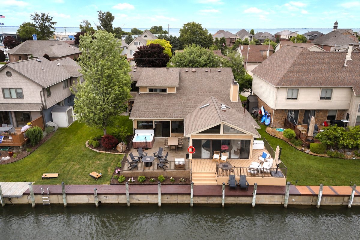 Waterfront home with a private canal-front deck, outdoor seating, and direct access to calm lake waters. Scenic and peaceful setting perfect for relaxing, entertaining, and enjoying true lakefront living.