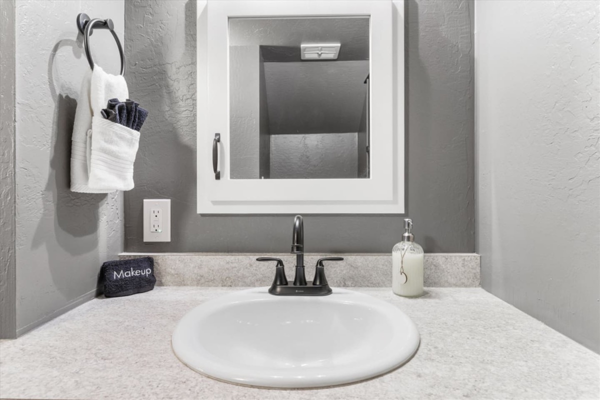 Bathroom vanity withcounter space, and simple essentials for getting ready.

