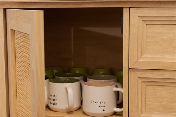 Access to coffee and tea cups, coffee and tea bags, and sugar are all in the cupboard below.