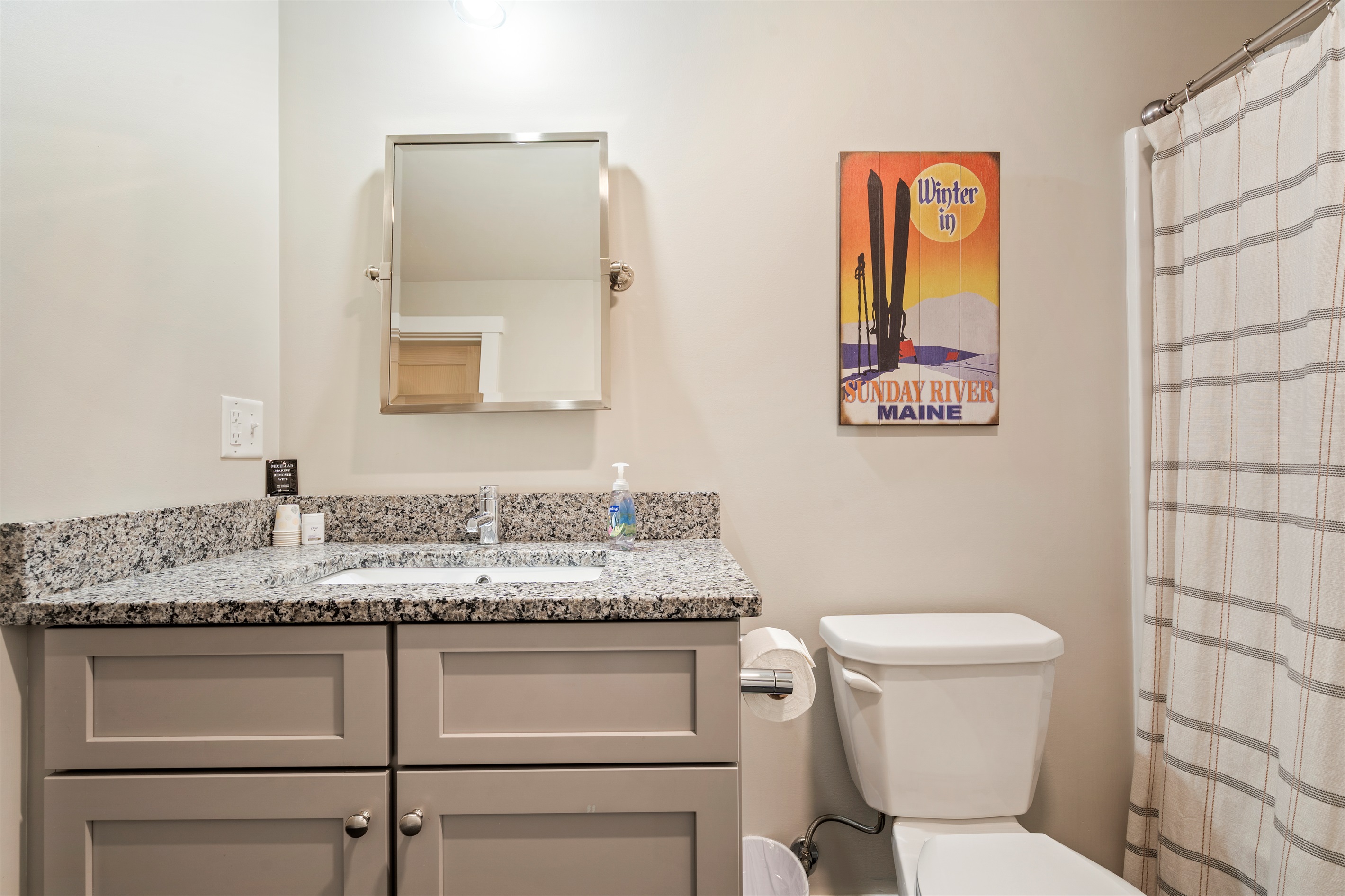 Basement bathroom featuring a full shower and tub combination with toilet.