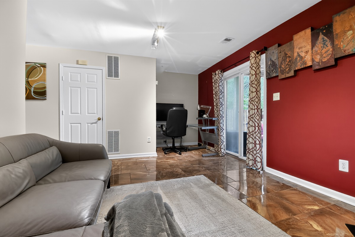 Second Living Room — Lower Level Flex Space, Red Accent Wall, Separate Seating Area