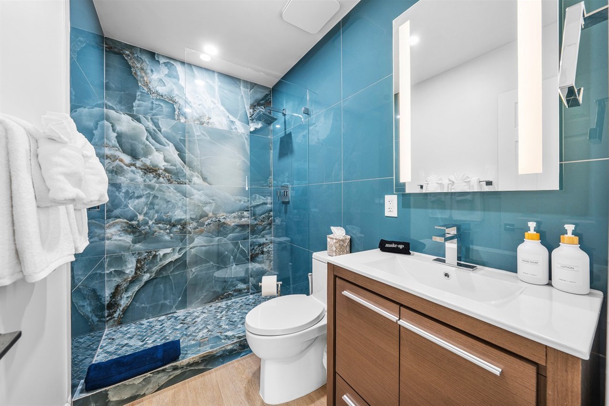 Spa-like bathroom with striking blue tile and modern finishes