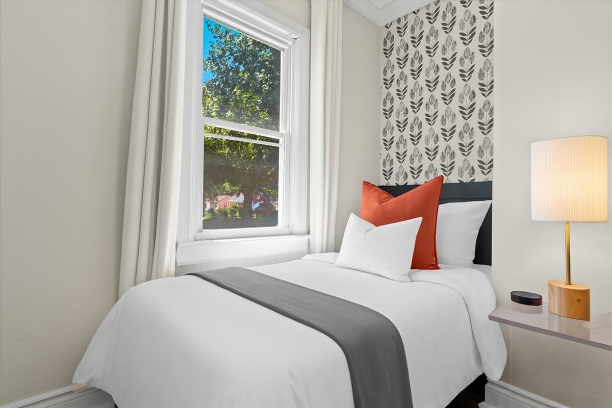 Charming bedroom with queen bed and accent wall design