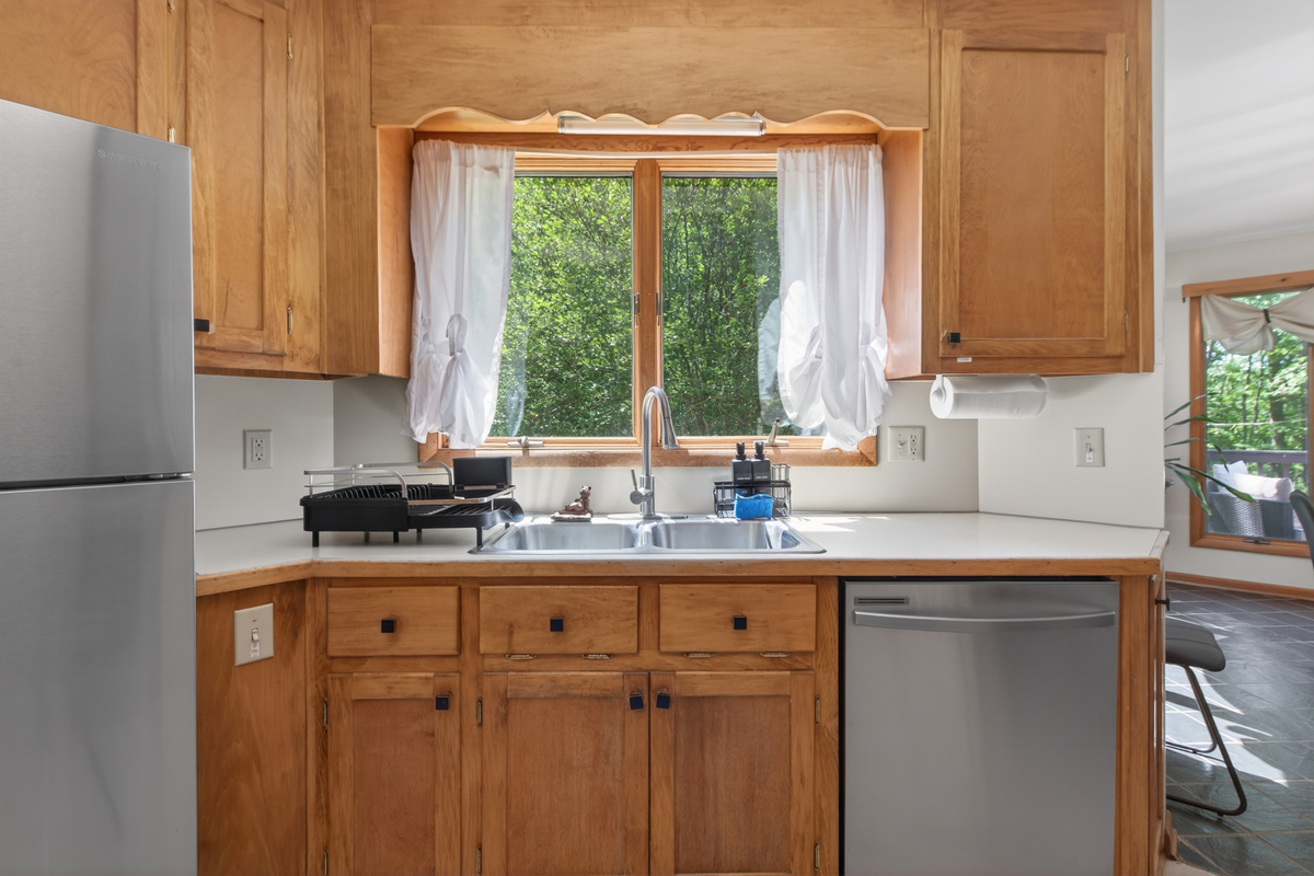 Kitchen: Sunlit space with modern appliances and serene views invites delightful meal prep!