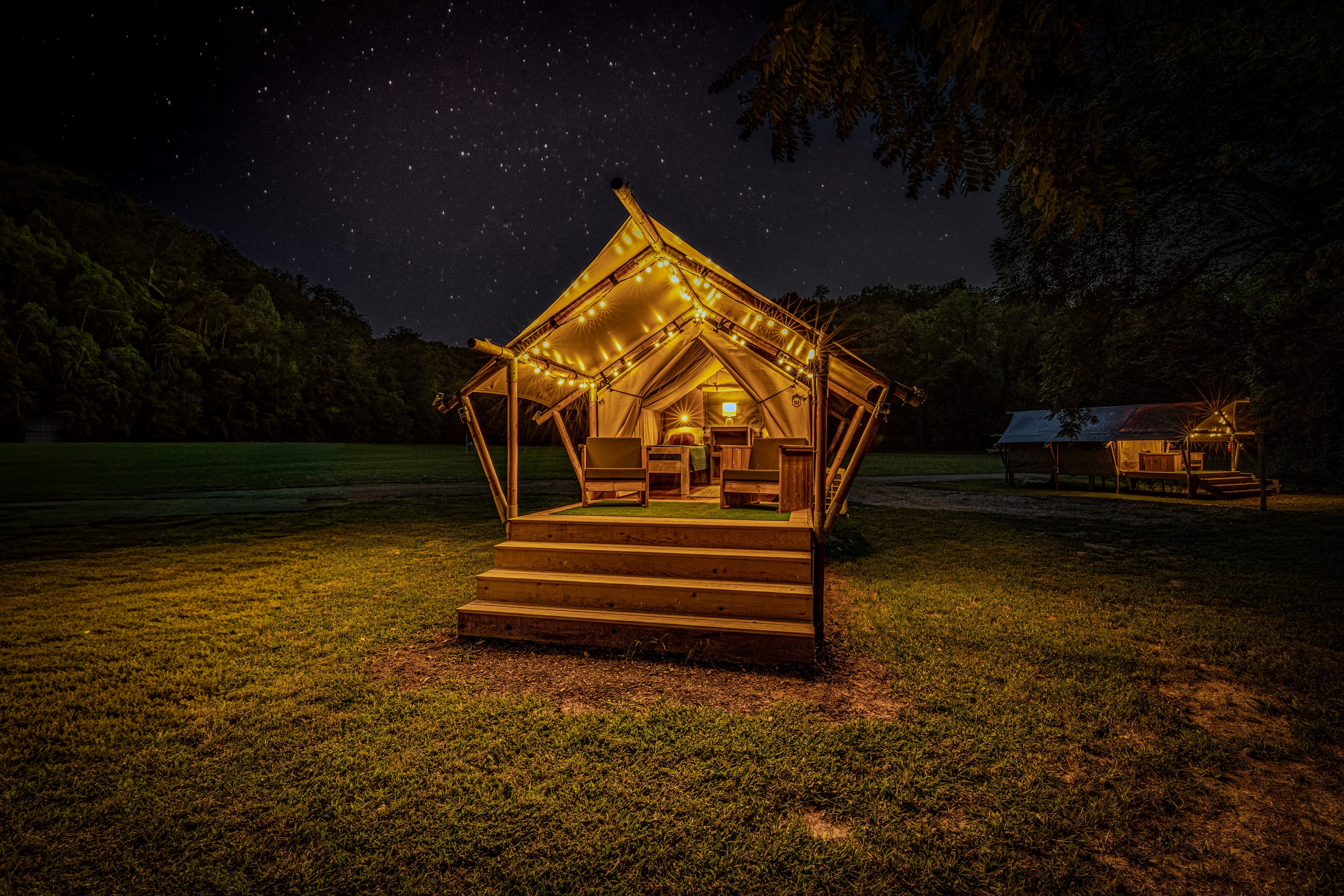 Welcome to your illuminated haven. The structure of the tent creates a beautiful, glowing ceiling for your private outdoor lounge area.