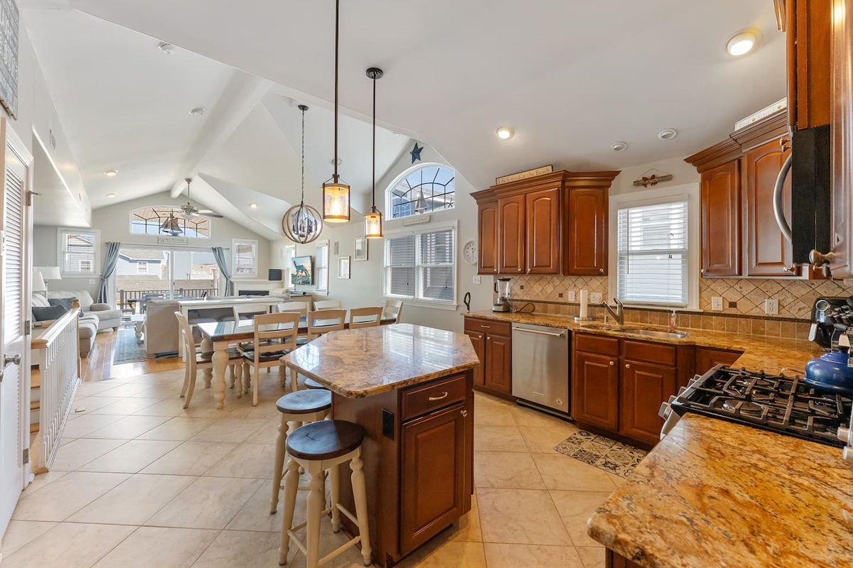 Full kitchen with stainless steel appliances, large island for additional seating, ample prep space and separate beverage refrigerator. 