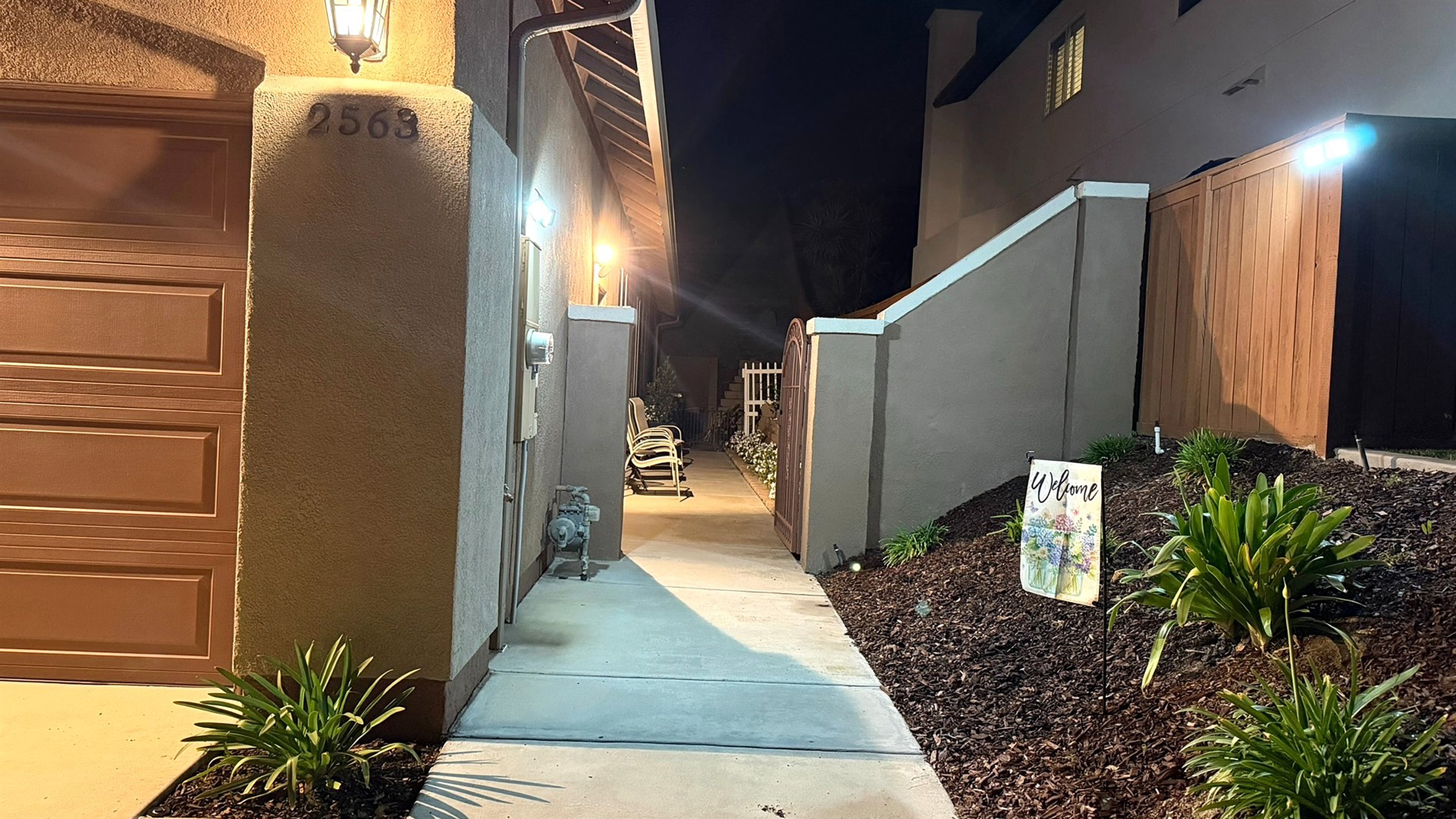 Well-lit path to private entrance at night