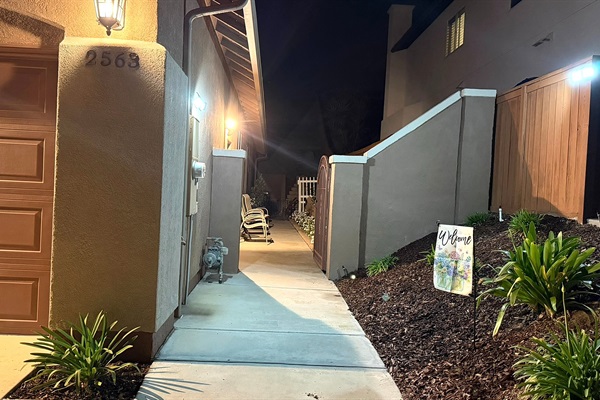 Well-lit path to private entrance at night