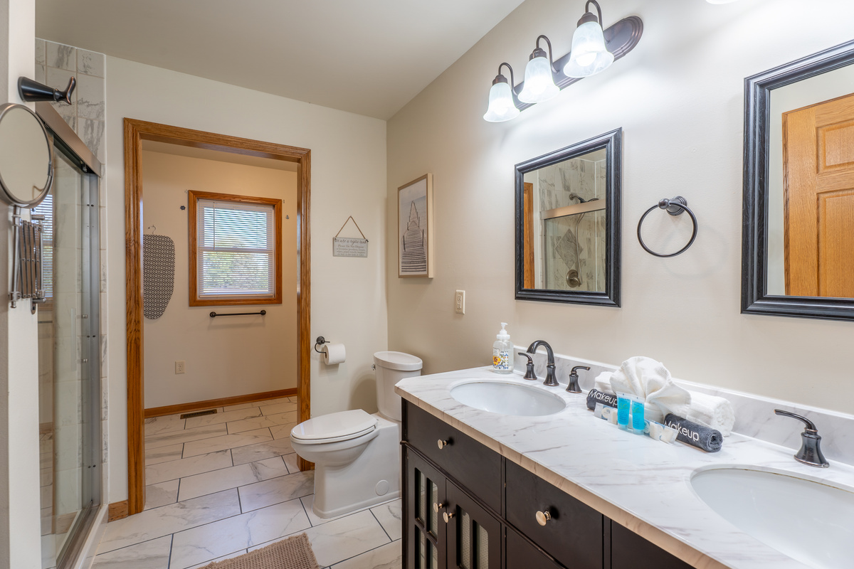 The main floor master en-suite - double vanity, walk-in shower, and everything you need to feel like you never left home