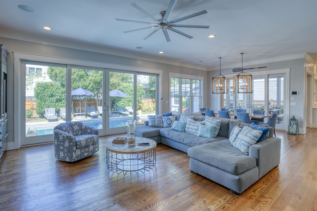 Wall of glass doors opens to the backyard oasis