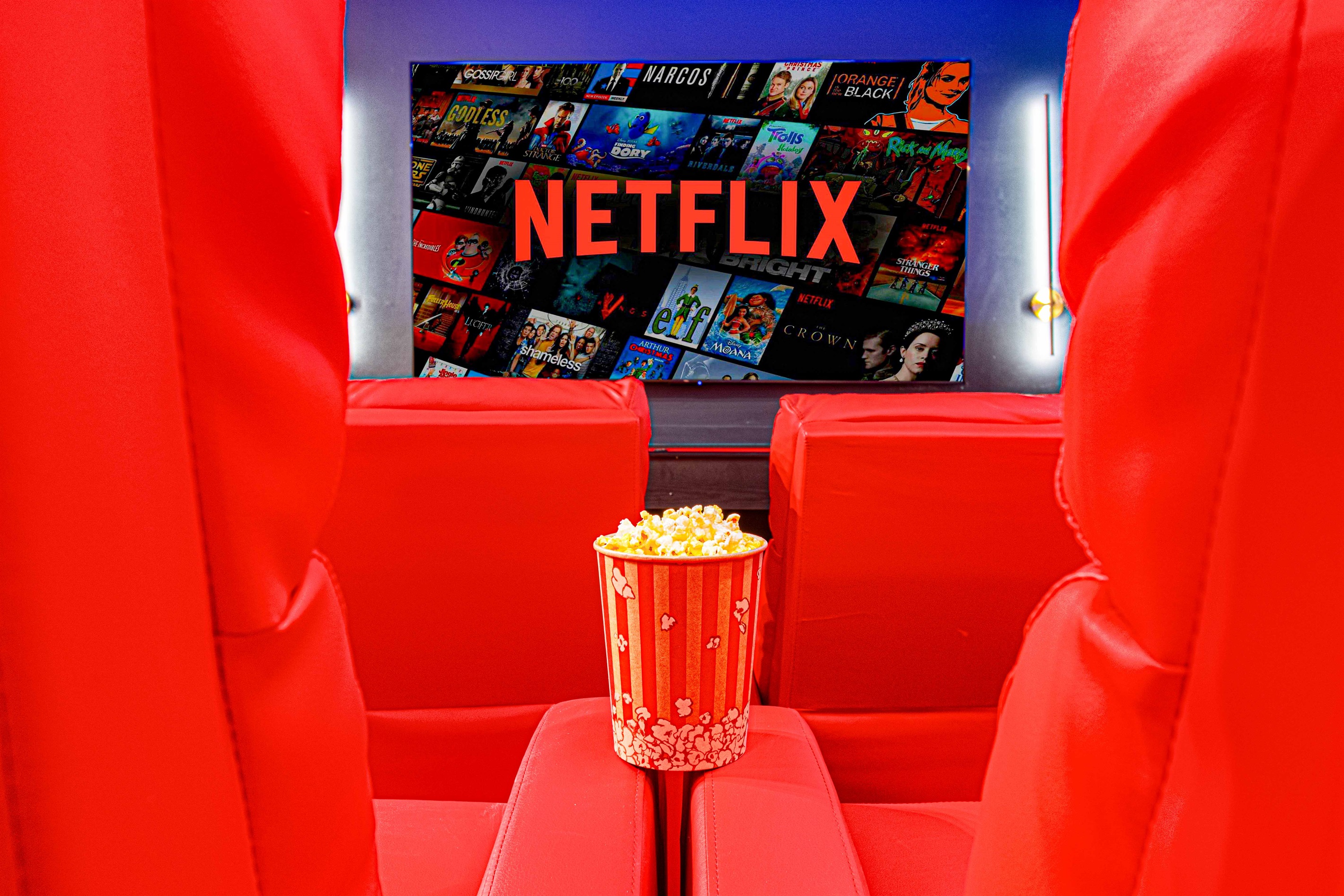 Settle into plush red movie seat recliners, grab some popcorn, and enjoy your favorite Netflix shows in this private home theater.