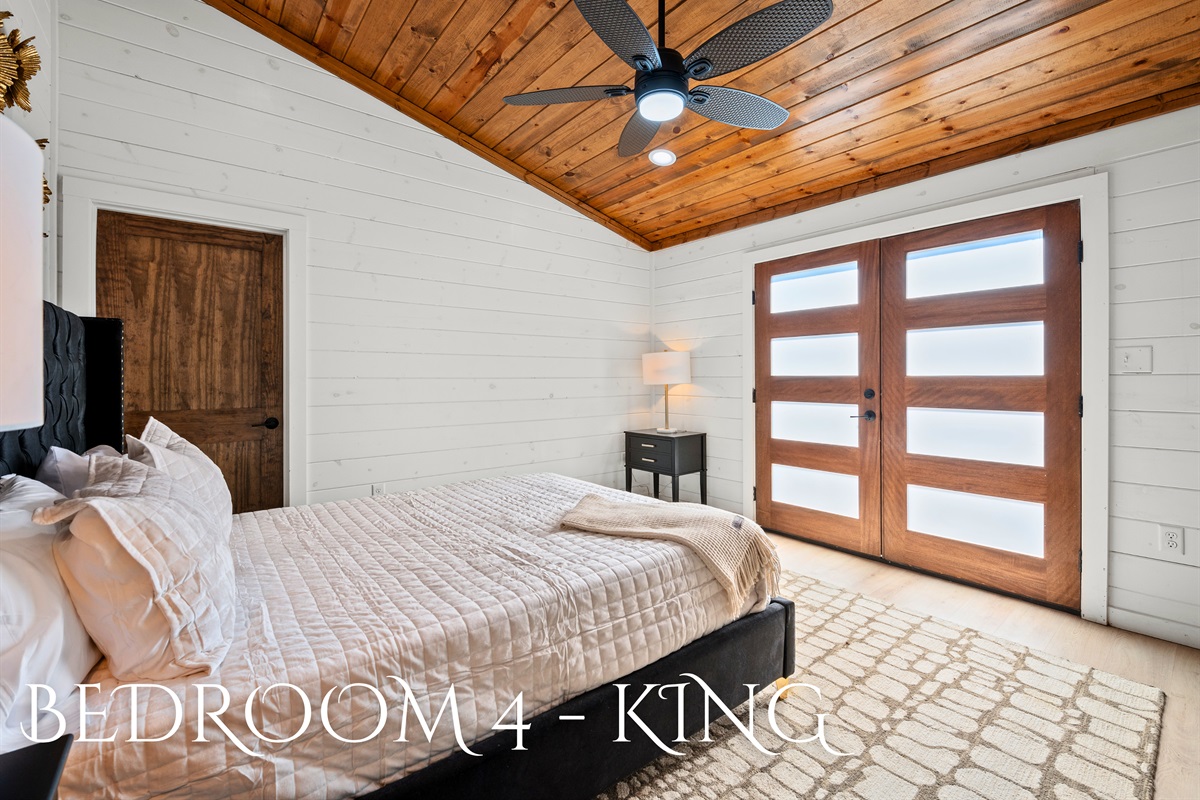 A welcoming king bedroom with warm wood ceilings, soft linens, and a peaceful atmosphere to help you recharge.
