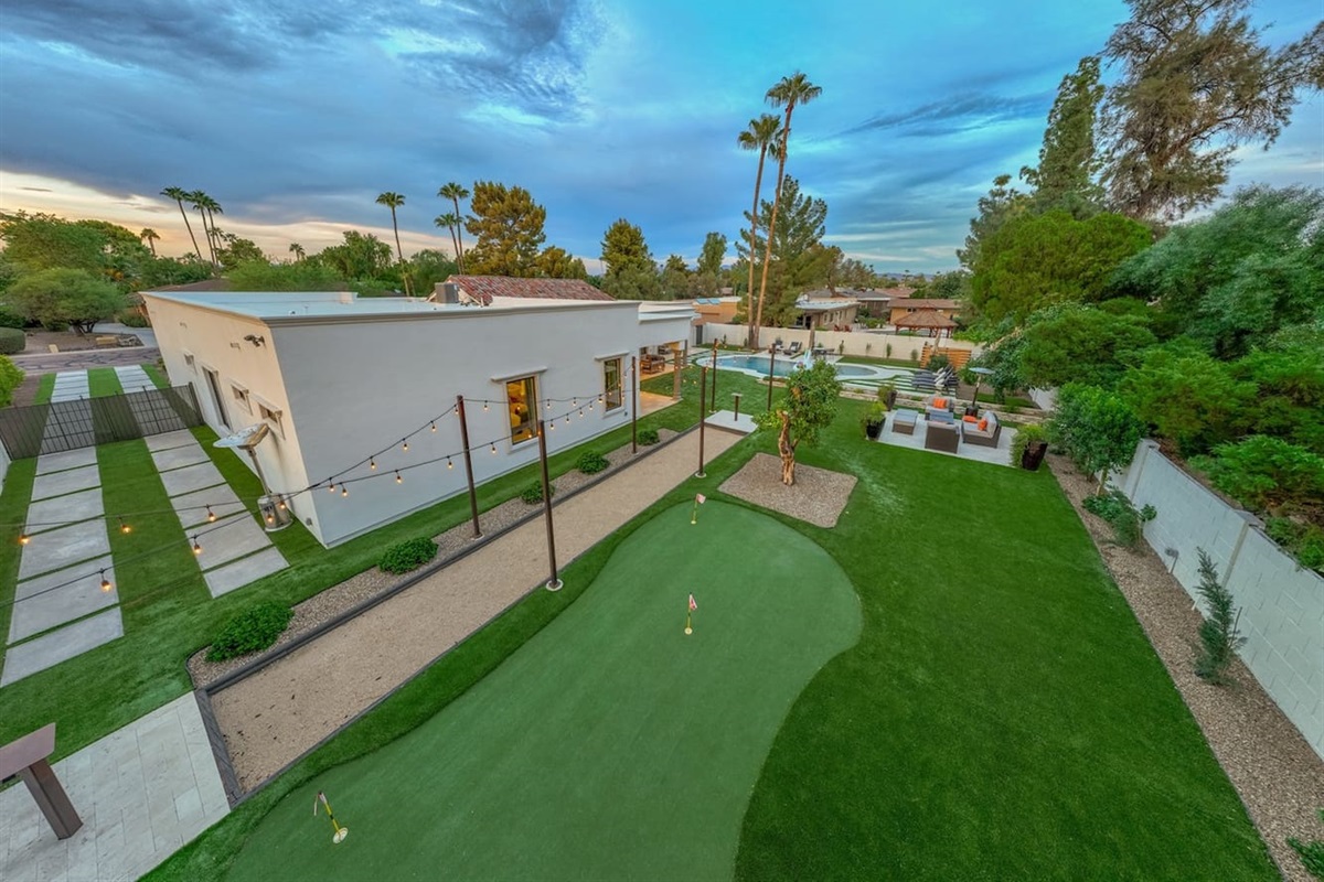 Play, relax, and unwind in our stunning outdoor space! Featuring a golf area, inviting pool, and charming lighted pathways, this is the ultimate retreat for your next getaway—reserve your stay!