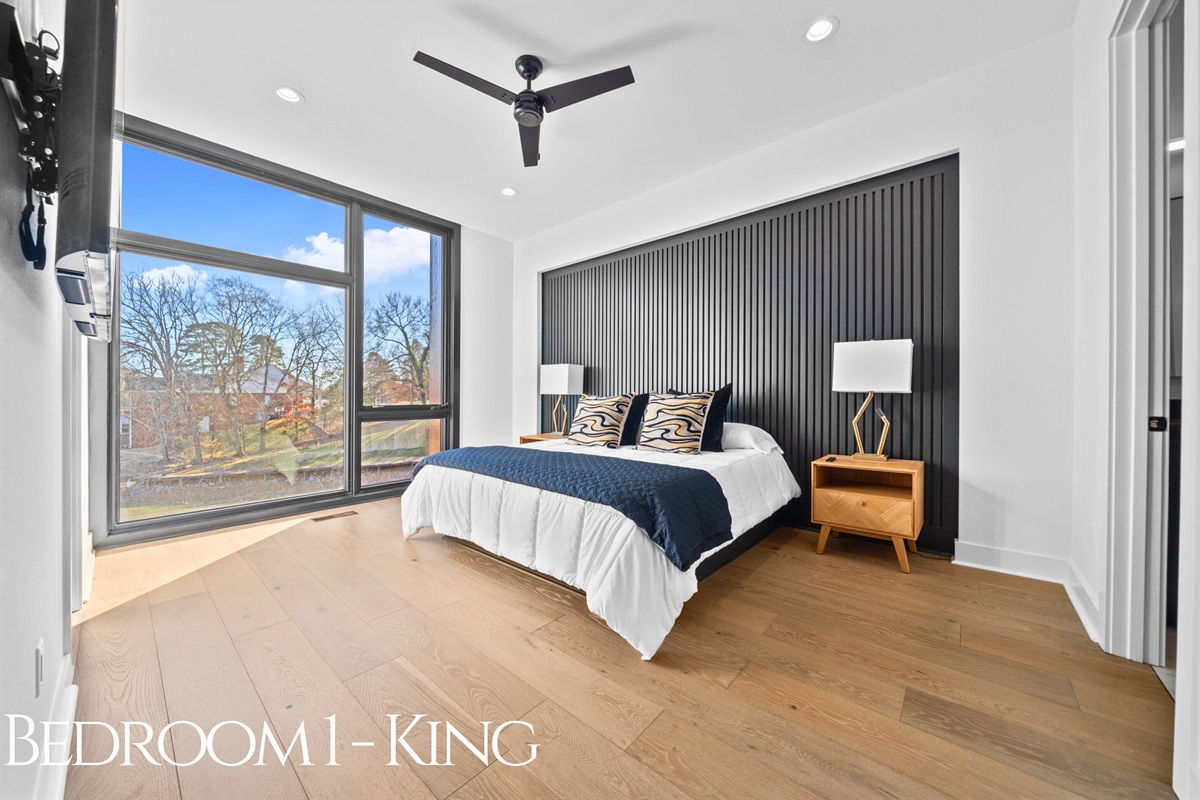 A serene and luxurious king bedroom with large windows, inviting textures, and rich accents, providing the ultimate retreat to relax and recharge.