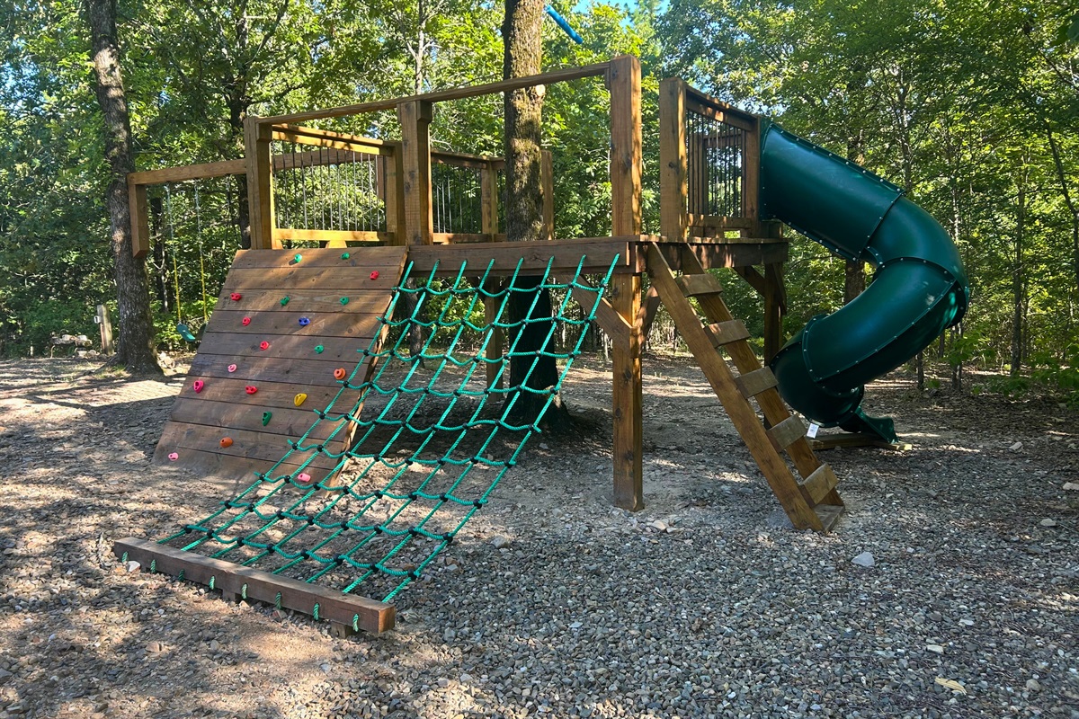 Adventure playset with rope net, slide, and ladder for endless outdoor fun.
