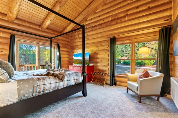 Spacious master suite featuring a king bed, TV, dresser, and private bath.