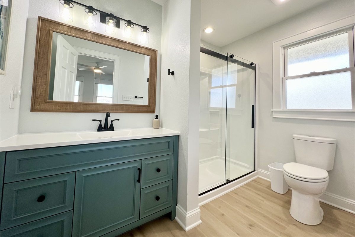 walk-in shower and large vanity with plenty of storage