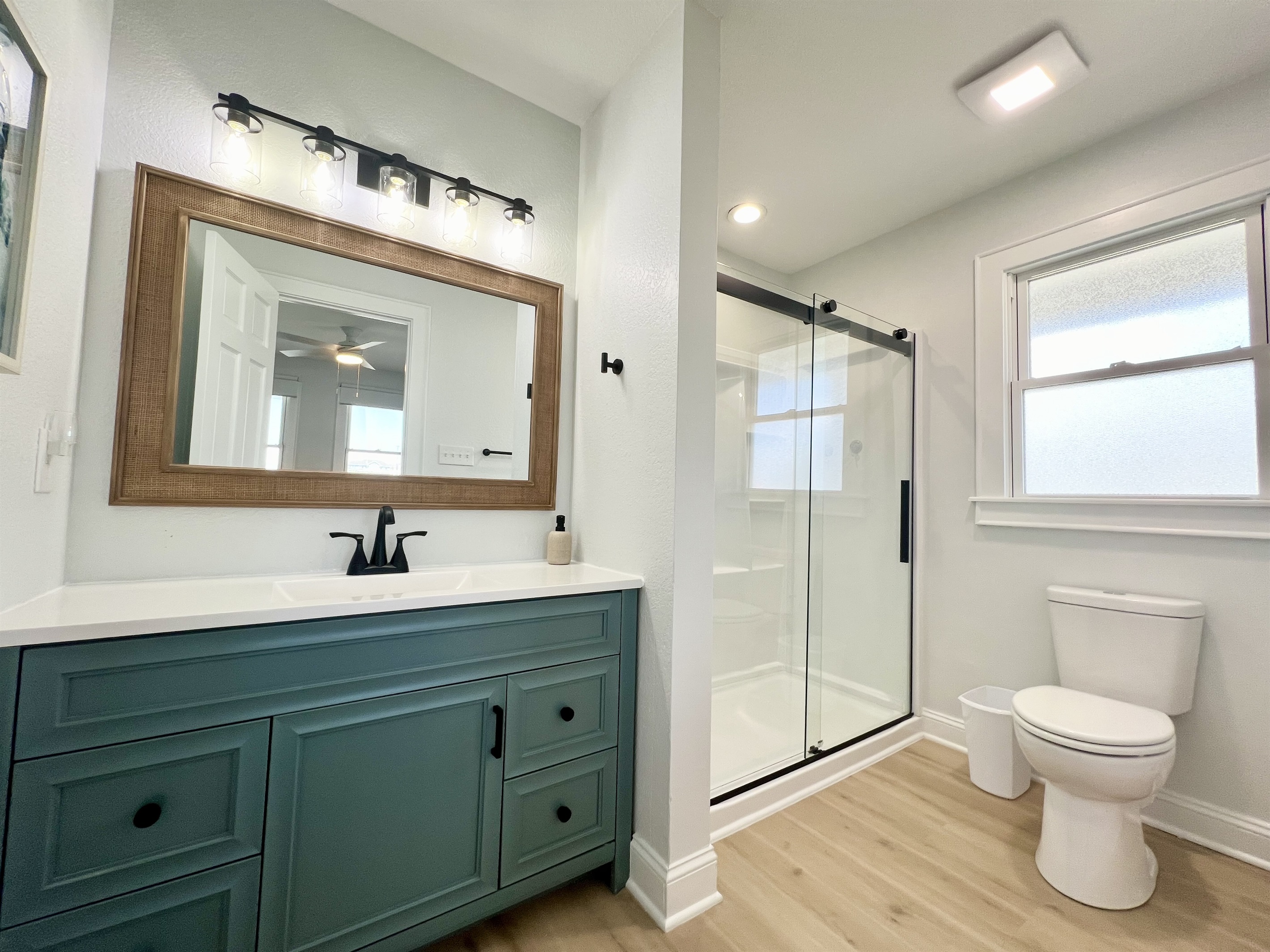 walk-in shower and large vanity with plenty of storage