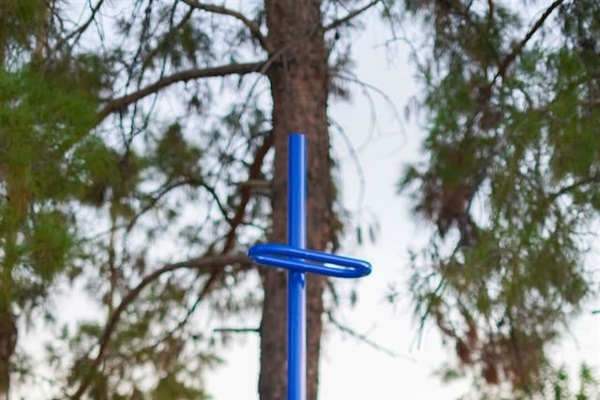 Get fit outdoors at the exercise stations, featuring multiple bars designed for a variety of workouts and exercises. This is a reverse leg raise to unleash those abs!
