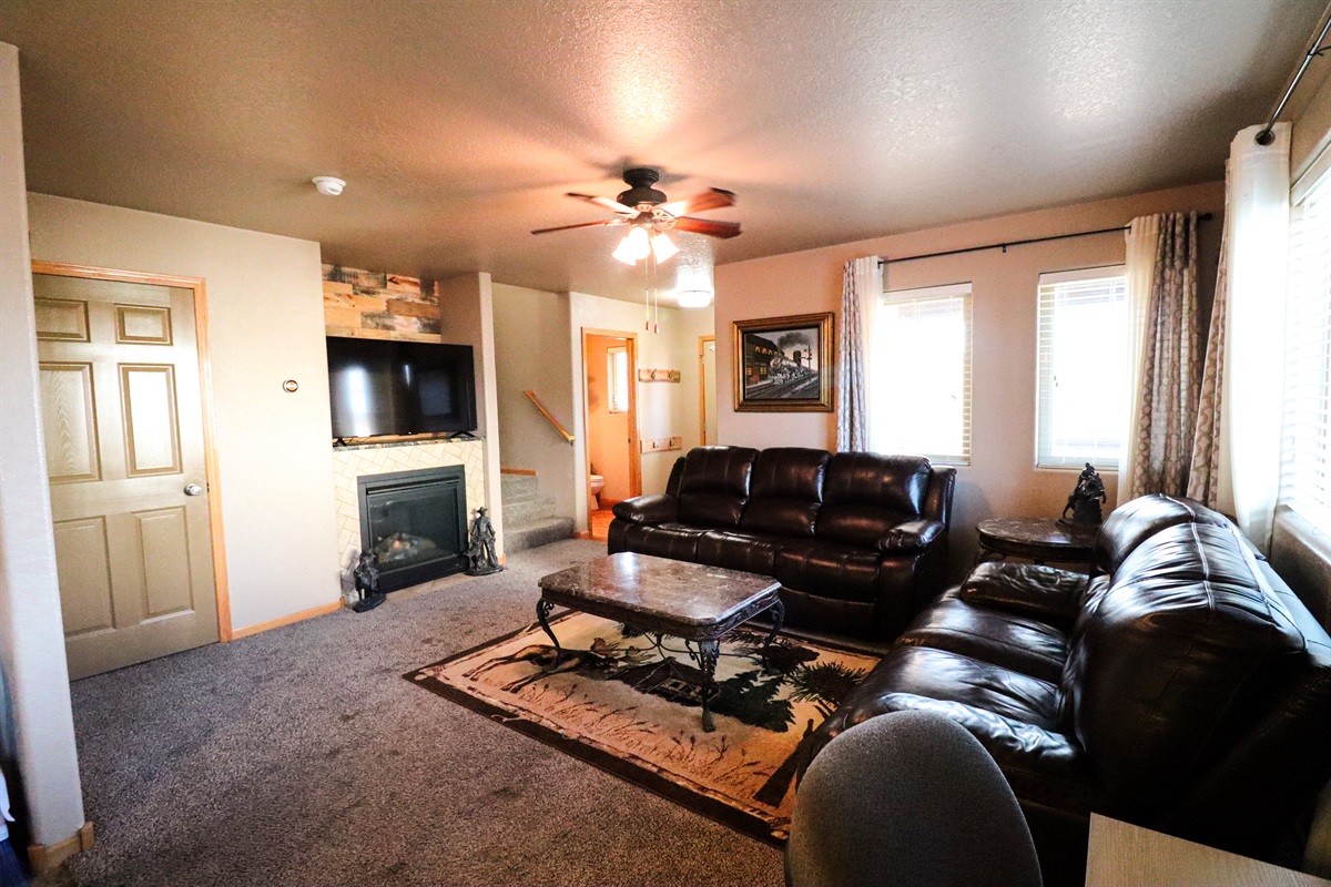 Living room with gas fireplace and half bath off the main living space