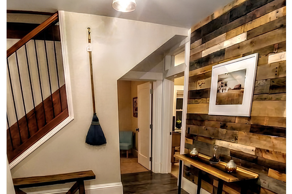 Common area on lower level leads laundry, bedrooms and storm shelter that doubles as a second living room.