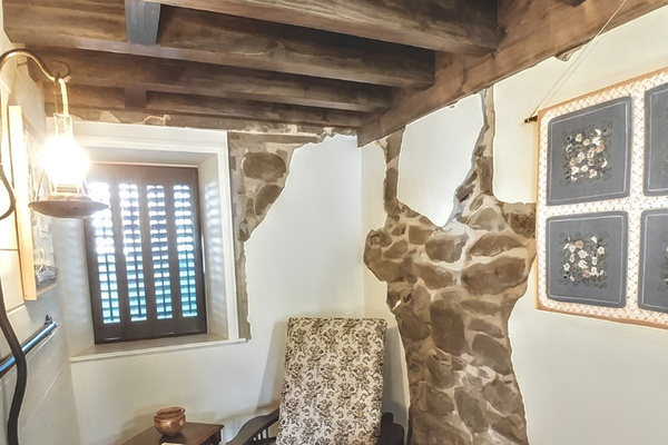 Lower Level Bedroom Suite features a sitting area with exposed sandstone blocks mined from a nearby quarry almost 150 years ago