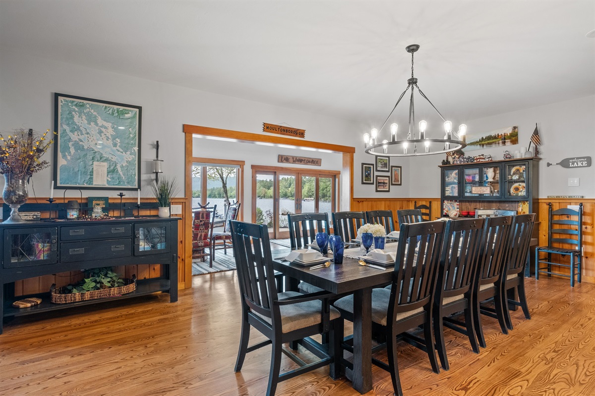 Dining area with seating for 10 plus 3 more at the kitchen island and 4 more at the barrel table near wooden posts