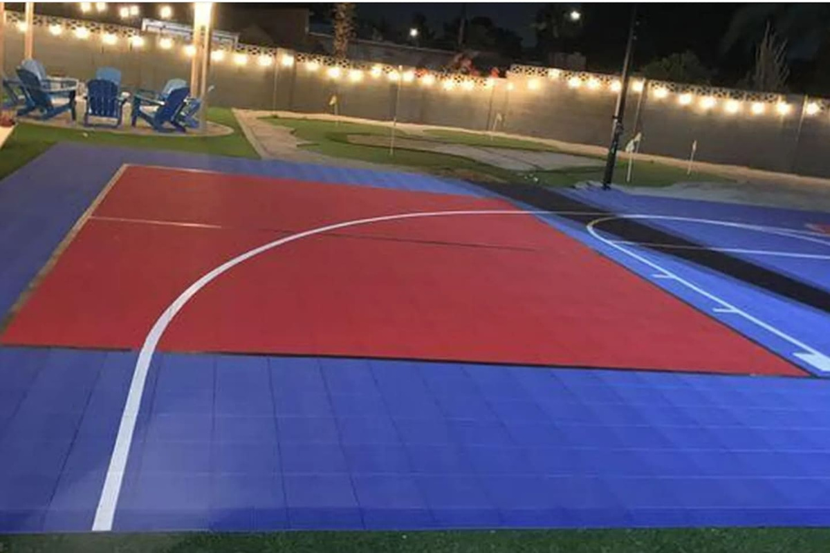 String lights strung overhead, lounge chairs just off the court — built for late-night games and even later conversations.