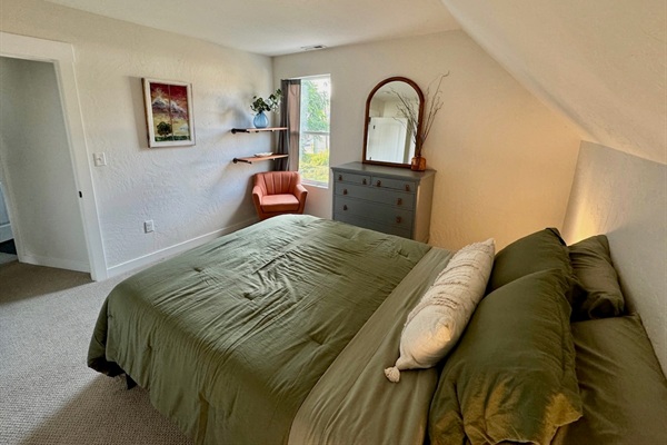This bedroom features a queen bed, black out curtain, and a generous walk-in closet space. 