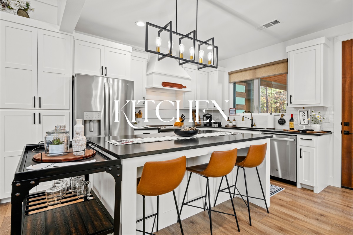 The kitchen features modern finishes, clean lines, and a spacious island designed for gathering and everyday meals.