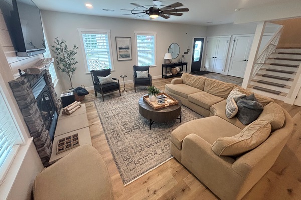Relax in our spacious living area, featuring cozy seating, a stunning fireplace, and natural light pouring in through the windows. Perfect for family gatherings or a quiet retreat. Experience comfort and style in every corner!