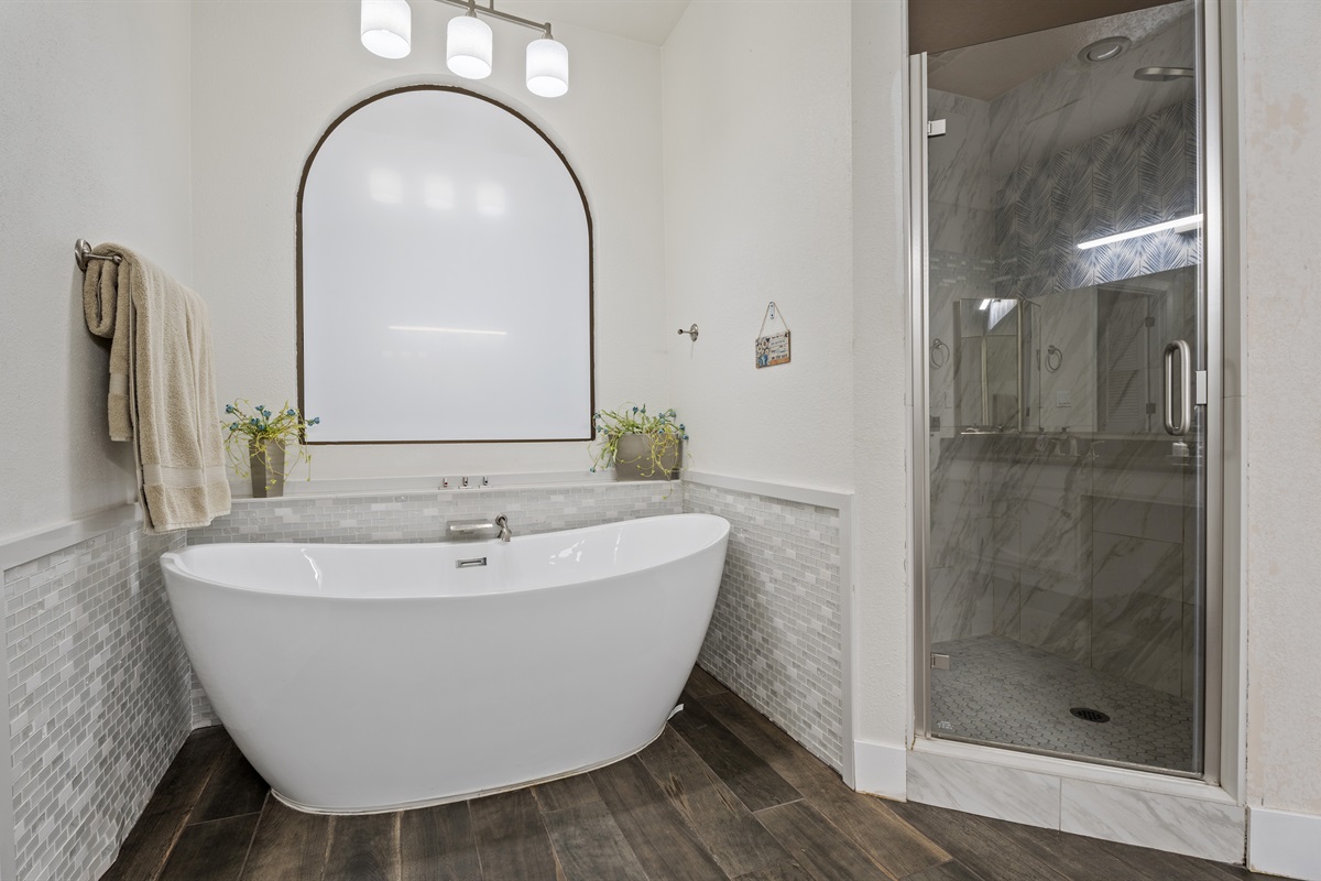 Pamper yourself in this spa-inspired bathroom with a freestanding tub, double sinks, and soothing neutral finishes.